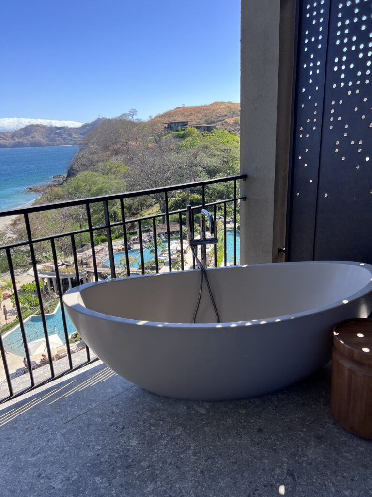 Outdoor balcony bathtub overlooking the pools and ocean at Waldorf Astoria Cacique Costa Rica