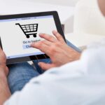 Person adding a purchase to their online cart