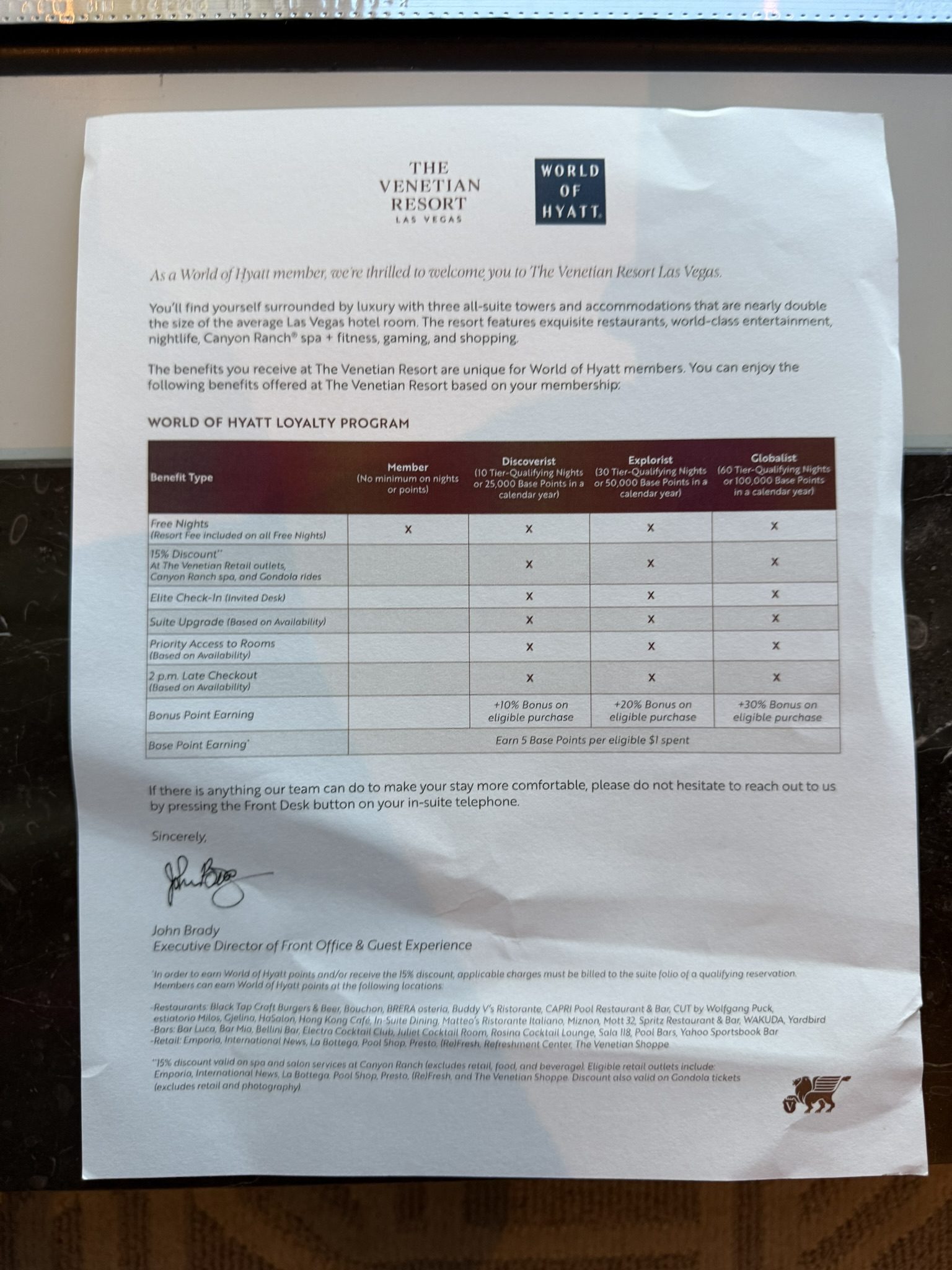 Printed World of Hyatt loyalty program benefits sheet from The Venetian Resort Las Vegas, showing Globalist, Explorist, Discoverist, and Member perks in a comparison chart.