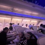 Fiji Airways A330 business class cabin at night with 2-2-2 seat configuration and passengers resting during the Hong Kong to Nadi flight.